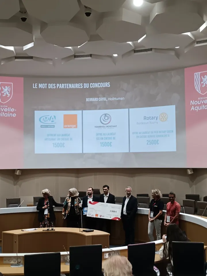 Sur la scène de l'hémicycle de la Région Nouvelle-Aquitaine, l'équipe IEyes tient un grand chèque de 1 500 euros, entourée des partenaires du concours.